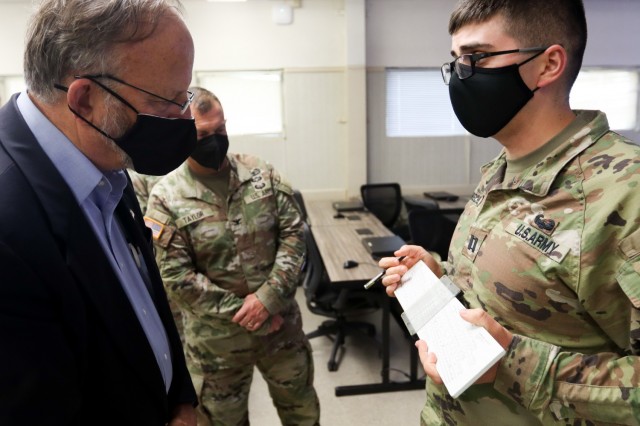 Field artillery instructors show Jack Surash, Acting Assistant Secretary of the Army for Installations, Energy and Environment, how they would perform degraded operations.