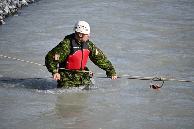 Brig. Gen. Louis Lapointe, deputy commanding general of U.S. Army Alaska, crosses Phelan Creek in Central Alaska on August 18 while observing the final day of training for the students of the Basic Military Mountaineering Course conducted at the Black Rapids Training Site of the Northern Warfare Training Center. The source of the creek is Gulkana Glacier, and the water temperature was approximately 38 degrees Fahrenheit. (Photo by Eve Baker, Fort Wainwright Public Affairs Office)