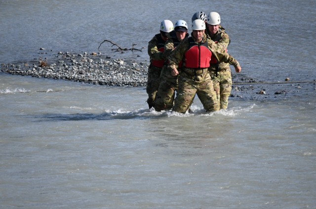 A group of leaders from U.S. Army Alaska practices an un-roped river crossing technique in Phelan Creek in central Alaska. The creek’s source is Gulkana Glacier in the Alaska Range, and the water temperature on the day of the crossing was approximately 38 degrees Fahrenheit. (Photo by Eve Baker, Fort Wainwright Public Affairs Office)