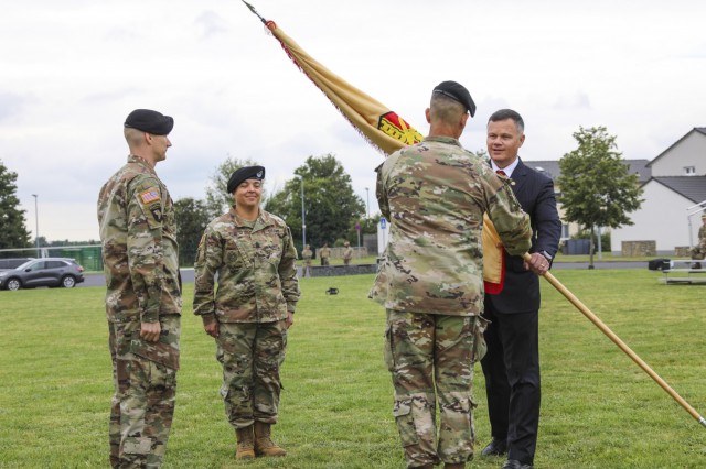 IMCOM-Europe Director Tommy Mize passes the colors to incoming Command Sgt. Maj. Christopher Truchon during the Change of Responsibility ceremony Aug. 27 at USAG Wiesbaden&#39;s Clay Kaserne.