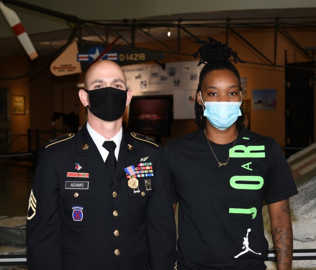 U.S. Army Staff Sgt. Travis M. Adams, a flight medic with Fort Rucker's air ambulance detachment, stands with Zyisha Carson, the survivor of a multivehicle accident Adams responded to in his off-duty time in Ozark, Alabama last year, just after Adams was presented the Soldier's Medal at the U.S. Army Aviation Museum Aug. 27, 2021. (U.S. Army photo by Kelly Morris)