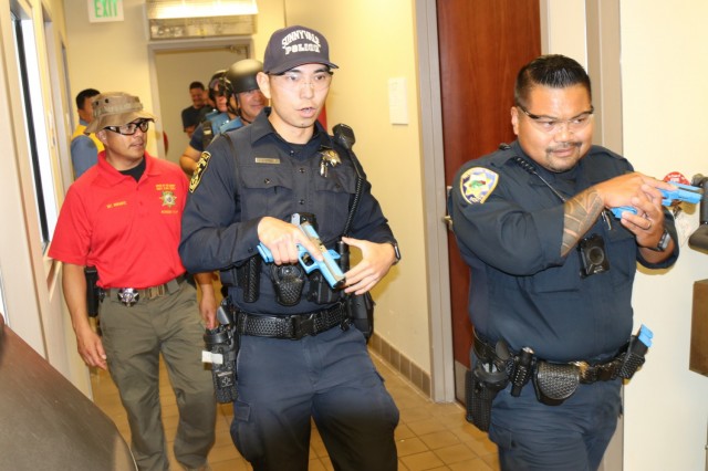 Left to right, as Sgt. Edward Durante, an exercise proctor from the Santa Clara County Sheriff’s Office, walks alongside Public Safety Officer S. Kotani, Sunnyvale Department of Public Safety (Law), and Police Officer Alan Corpuz from the Mountain View Police Department, as they co-lead a Rescue Task Force during active-shooter response training, at the Sgt. James Witowski Armed Forces Reserve Center, in Mountain View, California, Aug. 26, 2021.