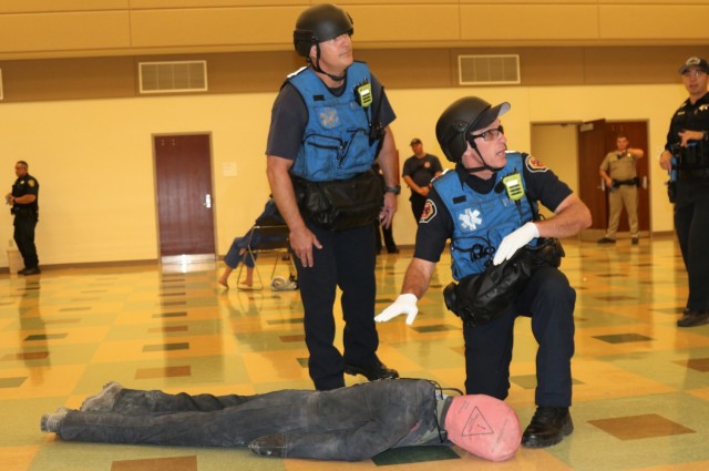 Left, Lt. Bryan Smart and Public Safety Officer Bradley Militano, both from the Sunnyvale Department of Public Safety (Fire) assess a simulated casualty as members of a Rescue Task Force during active-shooter response training, at the Sgt. James Witowski Armed Forces Reserve Center, in Mountain View, California, Aug. 26, 2021.