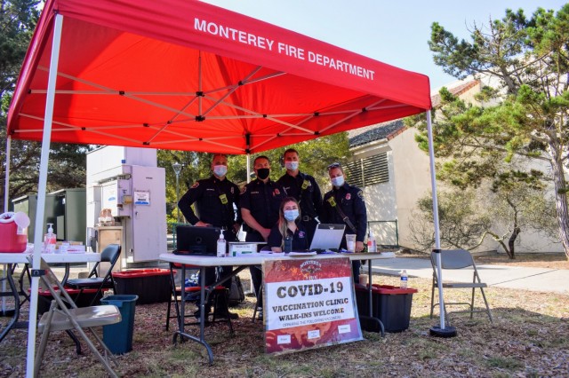 From left, Monterey Fire Department Capt. Dave Meurer, Assistant Chief Jim Courtney, Paramedic Brendan Coalwell, Paramedic Shelli Bezouska and, sitting, Fire Prevention Technician Kristine Wade get ready to provide COVID-19 vaccinations during the Volksmarch at the Presidio of Monterey, Calif., Aug. 28.
