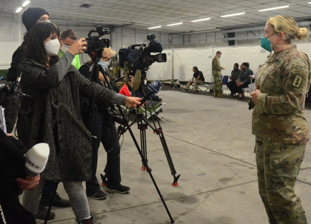 Maj. Karyn Kagel, an emergency medicine physician assistant with the 30th Medical Brigade, speaks to reporters on the health care being provided to evacuees at the Rhine Ordnance Barracks housing area.
