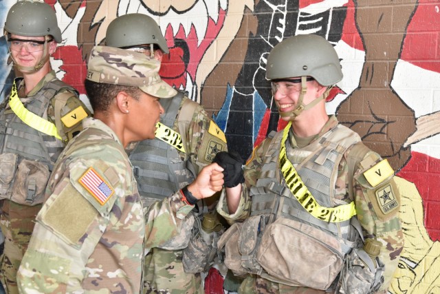 Command Sgt. Maj. Chalawnda M. Kelley, Command Sergeant Major 232nd Medical Battalion, fist bumps Pfc Ryan Jones after he was recognized with a commander’s coin.