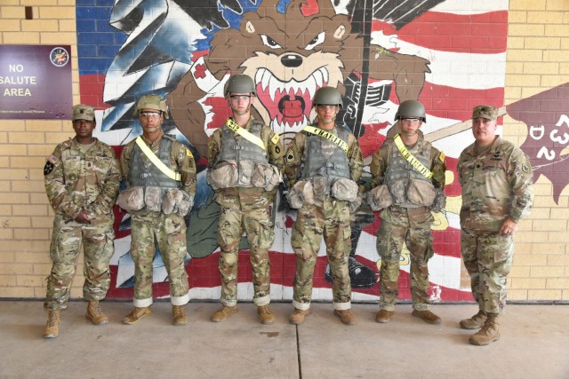 (left to right) Command Sgt. Maj. Deanna Carson, 187th Medical Battalion Command Sergeant Major with Pfc Jalun Taylor, Pfc Blair Sutcliffe, Pfc Jaden King, and Pfc Ryan Jones, from C. Co. 232nd Medical Battalion, with Lt. Col. Dennis Segui, Commander 187th Medical Battalion. LT. Col. Segui presented the four Soldiers with commander’s coins to recognize their selfless service in helping a fallen man at the Fort Sam Houston Exchange.