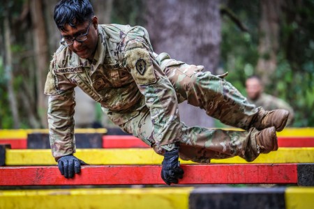 A soldier jumps over an obstacle during a “This Is My Squad” competition at Schofield Barracks, Hawaii, July 29, 2021. The 36-hour event aims to build strong, cohesive teams through tough, realistic training.