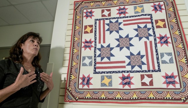 Diane Murtha explains the Stars of Liberty Quilt currently on display at the Pentagon Quilts memorial in Washington, D.C., Aug. 20, 2021. The quilt is a collective project by the Black Forest Quilt Guild, a group Murtha and more than 70 German and Americans participated in while stationed in Stuttgart, Germany.