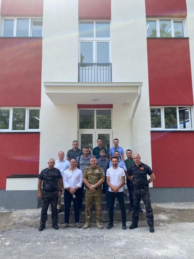 Project partners from the U.S. Army Corps of Engineers, U.S. Embassy in North Macedonia, U.S. Department of Justice’s International Criminal Investigative Training Assistance Program, U.S. European Command, the North Macedonian Ministry of Interior and the local contractor pose July 28, 2021 after walking through a recently completed barracks renovation at the Gjorce Petrov Police Compound in Skopje, North Macedonia. The project will enable more law enforcement professionals from North Macedonia and throughout the region to participate in training and exercises at the compound geared toward combating regional narcotic trafficking. (Courtesy Photo)