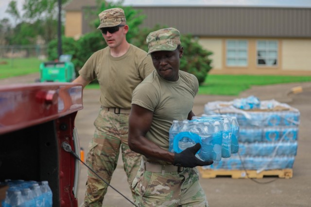 Oklahoma National Guard Sgt. Stephen Bruke hands out water at a point of distribution site in Gramercy, Louisiana, Sept. 4, 2021. The Oklahoma National Guard operates 13 PODs across seven parishes that supply families with tarps, meals ready to eat, ice and water. (Oklahoma National Guard photo by Cpl. Reece Heck)