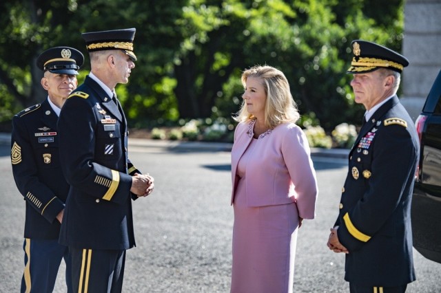 Secretary of the Army Christine E. Wormuth, second from right, Chief of Staff of the Army Gen. James C. McConville, right, and Sgt. Maj. of the Army Michael A. Grinston, left, speak with Maj. Gen. Allan Pepin, commander of the Joint Force Headquarters-National Capital Region and Army Military District of Washington in Arlington, Va., June 14, 2021. 