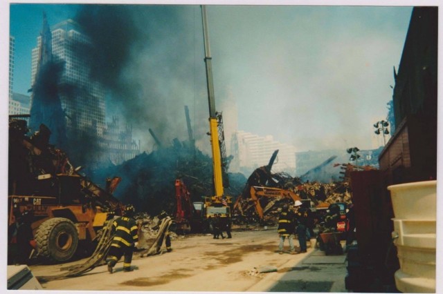 Crews from various agencies work to clear the still smoldering "rubble pile" at Ground Zero following the attack on the World Trade Center towers in Manhattan, New York, on Sept. 11, 2001. Immediately following the attack, work started on clearing debris in order to stabilize structures as well as search and recovery efforts for survivors and remains with over 14,000 New York National Guardsmen taking part in the response which lasted into 2002. (Photo courtesy of Edward Keyrouze)