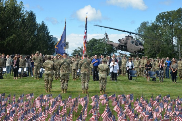 The color guard presents the flag during a 9/11 remembrance ceremony at New York National Guard headquarters in Latham, New York Sept. 10, 2021. The ceremony took place in front of a backdrop of 2,977 small American flags representing each of the people killed during the Sept. 11, 2001, attacks. ( U.S. Army National Guard photo by William Albrecht).