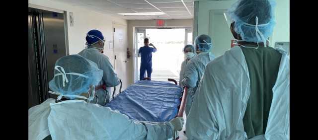 An Army Forward Resuscitative Surgical Team (FRST) prepares to receive a trauma patient as part of trauma scenario training provided by the Army Trauma Training Detachment and Ryder Trauma Center at Jackson Memorial in Miami, Florida, during pre-deployment training August 2021.