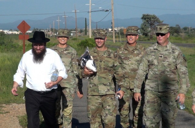 Rabbi Benzion Shemtov, a religious leader who serves Fort Huachuca, Ariz. walks on Fort Huachuca, Ariz. accompanied by Soldiers en route to the Main Post Chapel where he will lead a Rosh Hashanah service to celebrate the Jewish New Year. 