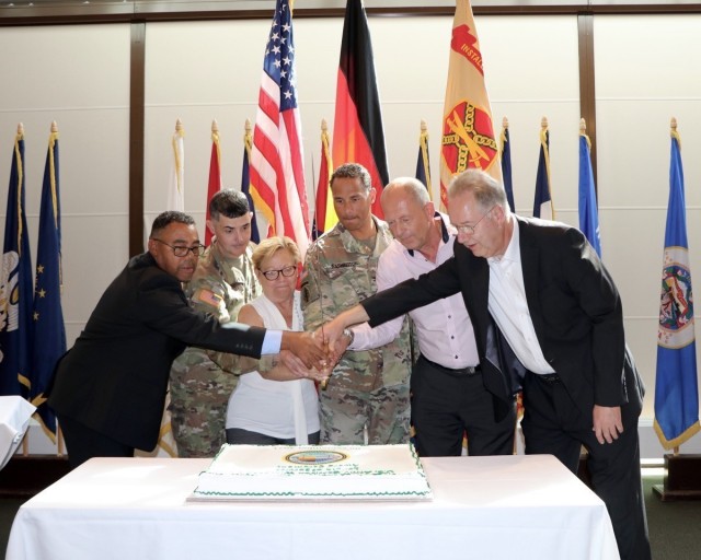 The 40 and 45 year awardees, Connie Dickey, Juergen Thieme and Klaus Herbst had the honor of cutting the cake with Wiesbaden Garrison Commander, Col. Mario Washington, Garrison Command Sgt. Maj. Richard Russell and Deputy to the Garrison Commander, Mitchell Jones.