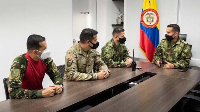 U.S. Army Chief Warrant Officer 3 Mauricio Garcia, meets with Lt. Col Milton Monroy, the Aviation Training Battalion commander, and staff at the Tolemaida Army Base, Colombia. Garcia, a UH-60M Black Hawk pilot and aviation safety officer, is deployed here as part of a technical advising team from Army Security Assistance Command’s Fort Bragg-based training unit, the Security Assistance Training Management Organization.