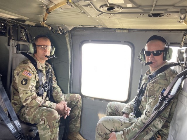 Command Sgt. Maj. Matthew Strasser and Command Sgt. Maj. Jeremy Strasser ride in a UH-60 Blackhawk during their deployment to Kosovo together in 2020. On Sept. 10, 2021, Matthew passed responsibility of the 2nd Infantry Brigade Combat Team, 34th Infantry Division, Iowa Army National Guard, to his younger brother Jeremy, marking a unique moment in Iowa National Guard history. The two brothers have dedicated a combined 47 years of service to the Red Bull brigade and have served on two deployments together. (U.S. Army National Guard photo by Staff Sgt. Tawny Schmit)