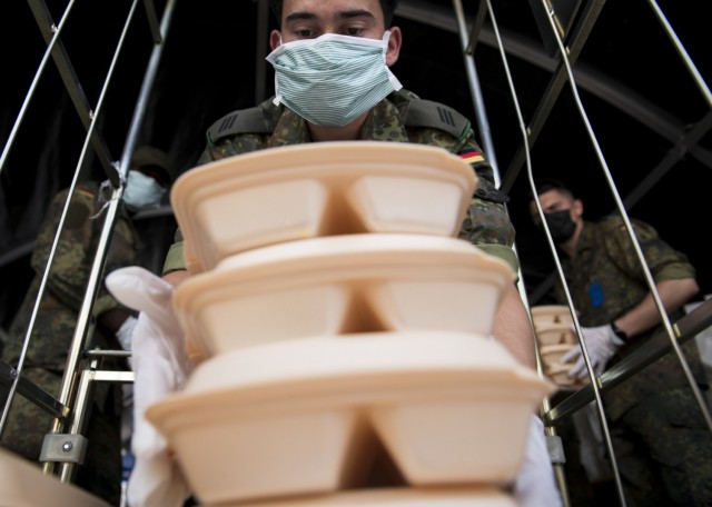 A German Bundeswehr soldier loads meals onto a cart during Operation Allies Refuge at Ramstein Air Base, Germany, Sept. 10, 2021. Soldiers from the German Bundeswehr worked shoulder to shoulder with U.S. Army and Air Force service members to prepare meals for the Afghanistan evacuees. Ramstein Air Base is a transit center that provides a safe place for the evacuees to complete their paperwork while security and background checks are conducted before they continue on to their final destination. (U.S. Army photo by Staff Sgt. Thomas Mort)