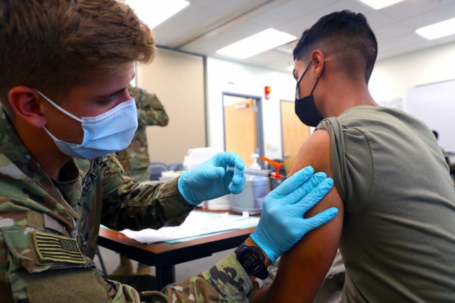 Spc. Tyler Boyer, a Hayden, Colorado native and medical specialist assigned to the 1st Stryker Brigade Combat Team, 4th  Infantry Division, administers the COVID-19 vaccine at Fort Carson, Colorado Aug 3, 2021. The 4th Inf. Div. remains committed to keeping the Fort Carson community safe and healthy by offering mobile vaccinations centers.  (U.S. Army photo by Sgt. Andrew Greenwood)