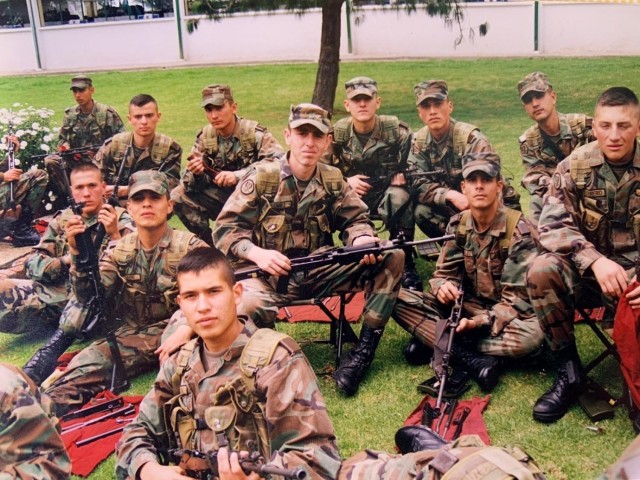Cadet Mauricio Garcia, without hat in foreground, and fellow classmates, pose for a photo during a field exercise at the military officer school in Bogota, Colombia. Garcia, now a Chief Warrant Officer 3 with the U.S. Army, is deployed to Tolemaida Army Base in Colombia as part of a technical advising team from U.S. Army Security Assistance Command’s Fort Bragg-based training unit, the Security Assistance Training Management Organization.