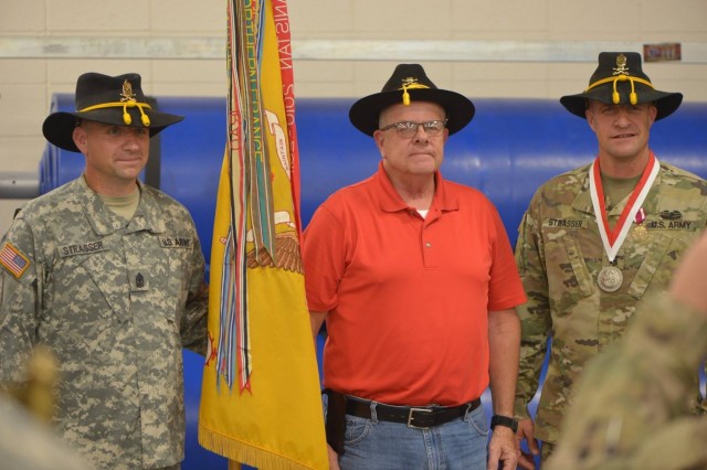 Ret. Sgt. Maj. Gary Strasser stands with his sons, then Sgt. Maj. Jeremy Strasser and Command Sgt. Maj. Matthew Strasser, during Matthew’s change of responsibility ceremony for the 2nd Infantry Brigade Combat Team, 34th Infantry Division, Iowa Army National Guard, at the Camp Dodge Joint Maneuver Training Center in September 2017. On Sept. 10, 2021, Matthew passed responsibility of the brigade to his younger brother Jeremy, marking a unique moment in Iowa National Guard history. The three Strassers have dedicated a combined 85 years of service to the Red Bull brigade. (U.S. Army National Guard photo by Staff Sgt. Tawny Schmit)
