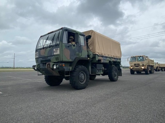 Light Medium Tactical Vehicles assigned to the Louisiana National Guard’s 527th Engineer Battalion, 225th Engineer Brigade, lead a convoy of dump trucks and flat-bottom boats to be staged in advance of Tropical Depression Nicholas at the Burton Coliseum in Lake Charles, Louisiana, Sept. 13, 2021. (U.S. Army National Guard photo by Staff Sgt. Gregory Stevens)