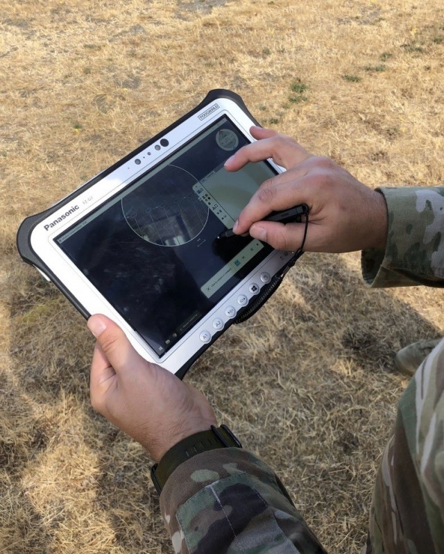 An Explosive Ordnance Disposal technician from the 707th Ordnance Company (EOD) operates a Skyraider Unmanned Aerial System during field testing on Joint Base Lewis-McChord, Washington.  The company was one of the first U.S. Army EOD companies to field the UAS system.  U.S. Army photo by Sgt. 1st Class Jeremy Walsh.