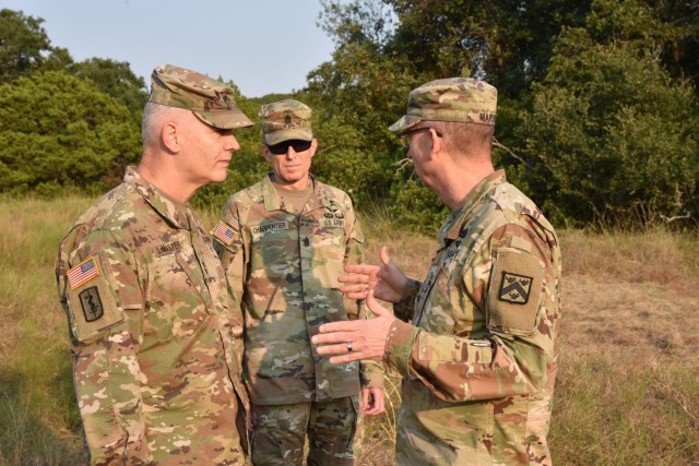 ASCIILt. Gen. Theodore Martin, Commander U.S. Army Combined Arms Center, or CAC, visited the U.S. Army Medical Center of Excellence, Joint Base San Antonio-Fort Sam Houston, Texas, September 8-10. Pictured (left to right), Maj. Gen. Dennis LeMaster, Cmd. Sgt. Maj. Clark Charpentier and Lt. Gen. Theodore Martin discuss 68W Combat Medic training during a Field Training Exercise at Joint Base San Antonio-Camp Bullis, September 10.  