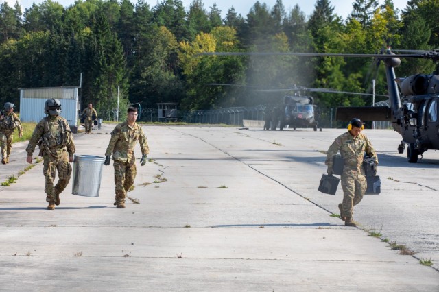 U.S. Soldiers assigned to 12th Combat Aviation Brigade, carry ammunition for an M240H weapon system on Grafenwoehr Training Area, Germany, Sep. 14, 2021. Soldiers assigned to 12th CAB are currently training for an event called Royal Black Hawk where they will train alongside the French military in October. 