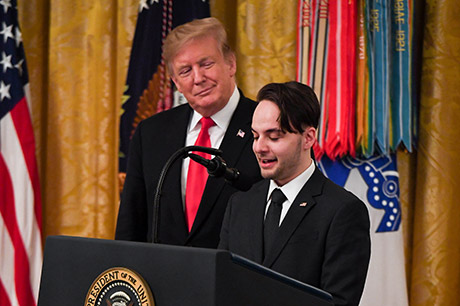 President Donald J. Trump posthumously awards the Medal of Honor to Staff Sgt. Travis W. Atkins at the White House in Washington D.C., March 27, 2019. Atkins’ son, Trevor Oliver, speaks to those in attendance at the ceremony. Atkins was posthumously awarded the Medal of Honor for actions while serving with Delta Company, 2nd Battalion, 14th Infantry Regiment, 2nd Brigade Combat Team, 10th Mountain Division, in Abu Sarnak, Iraq, in support of Operation Iraqi Freedom, on June 1, 2007. His extraordinary heroism in attempting to subdue a suicide bomber and shielding three Soldiers from the imminent explosion resulted in him being mortally wounded and saving the Soldiers. (U.S. Army photo by Spc. James Harvey)