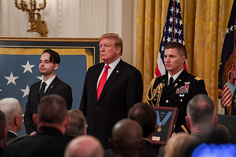 President Donald J. Trump posthumously awards the Medal of Honor to Staff Sgt. Travis W. Atkins at the White House in Washington D.C., March 27, 2019. Atkins was posthumously awarded the Medal of Honor for actions while serving with Delta Company, 2nd Battalion, 14th Infantry Regiment, 2nd Brigade Combat Team, 10th Mountain Division, in Abu Sarnak, Iraq, in support of Operation Iraqi Freedom, on June 1, 2007. His extraordinary heroism in attempting to subdue a suicide bomber and shielding three Soldiers from the imminent explosion resulted in him being mortally wounded and saving the Soldiers. (U.S. Army photo by Spc. James Harvey)