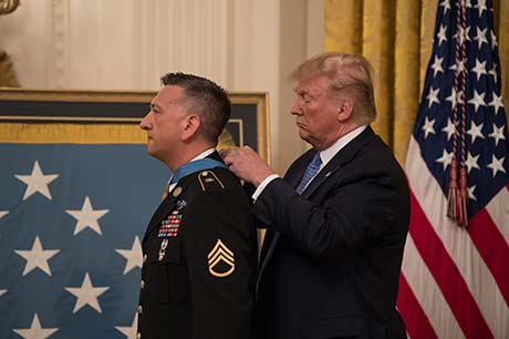 President Donald J. Trump presents the Medal of Honor to Staff Sgt. David G. Bellavia during a ceremony at the White House in Washington, D.C., June 25, 2019. Bellavia was awarded the Medal of Honor for actions while serving as a squad leader with the 1st Infantry Division in support of Operation Phantom Fury in Fallujah, Iraq, when a squad from his platoon became trapped by intense enemy fire. (U.S. Army Photo by Sgt. Kevin Roy)