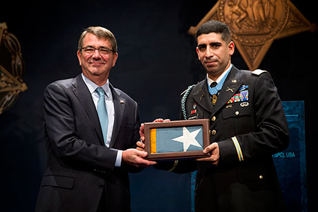 Secretary of Defense Hon. Ash Carter presents the Medal of Honor Flag to retired U.S. Army Capt. Florent Groberg during his Hall of Heroes induction ceremony Nov. 13, 2015, at the Pentagon, Arlington, Va. (U.S. Army photo by Mr. John G. Martinez)