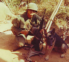 U.S. Army Pfc. James McCloughan poses with a dog while on a patrol in Vietnam, 1969. (Photo courtesy of former U.S. Army Spc. 5 James McCloughan)