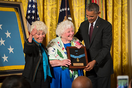 President Barack Obama bestows the Medal of Honor to Sgt. William Shemin, accepting on his behalf are his daughters, Elsie Shemin-Roth (middle) and Ina Bass (left), in the East Room of the White House, June 2, 2015. Shemin, a Jewish-American, distinguished himself as a member of 2nd Battalion, 47th Infantry Regiment, 4th Infantry Division, American Expeditionary Forces, during combat operations against the enemy on the Vesle River, near Bazoches, France, during World War I. While serving as a rifleman from August 7-9, 1918, Shemin left the cover of his platoon's trench and crossed open space in full sight of the Germans, repeatedly exposing himself to heavy machine gun and rifle fire to rescue the wounded. After officers and senior noncommissioned officers had become casualties, Shemin took command of the platoon and displayed great initiative under fire, until he was wounded, Aug. 9. Shemin was wounded by shrapnel and a machine-gun bullet that pierced his helmet that was lodged behind his left ear, leaving him partially deaf.
U.S. Army photo by Staff Sgt. Bernardo Fuller