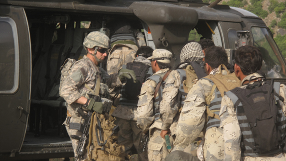 Capt. William Swenson leads Afghan Border Police members as they board a UH-60 Black Hawk helicopter, May 2009.