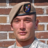 Soldier wearing tan beret